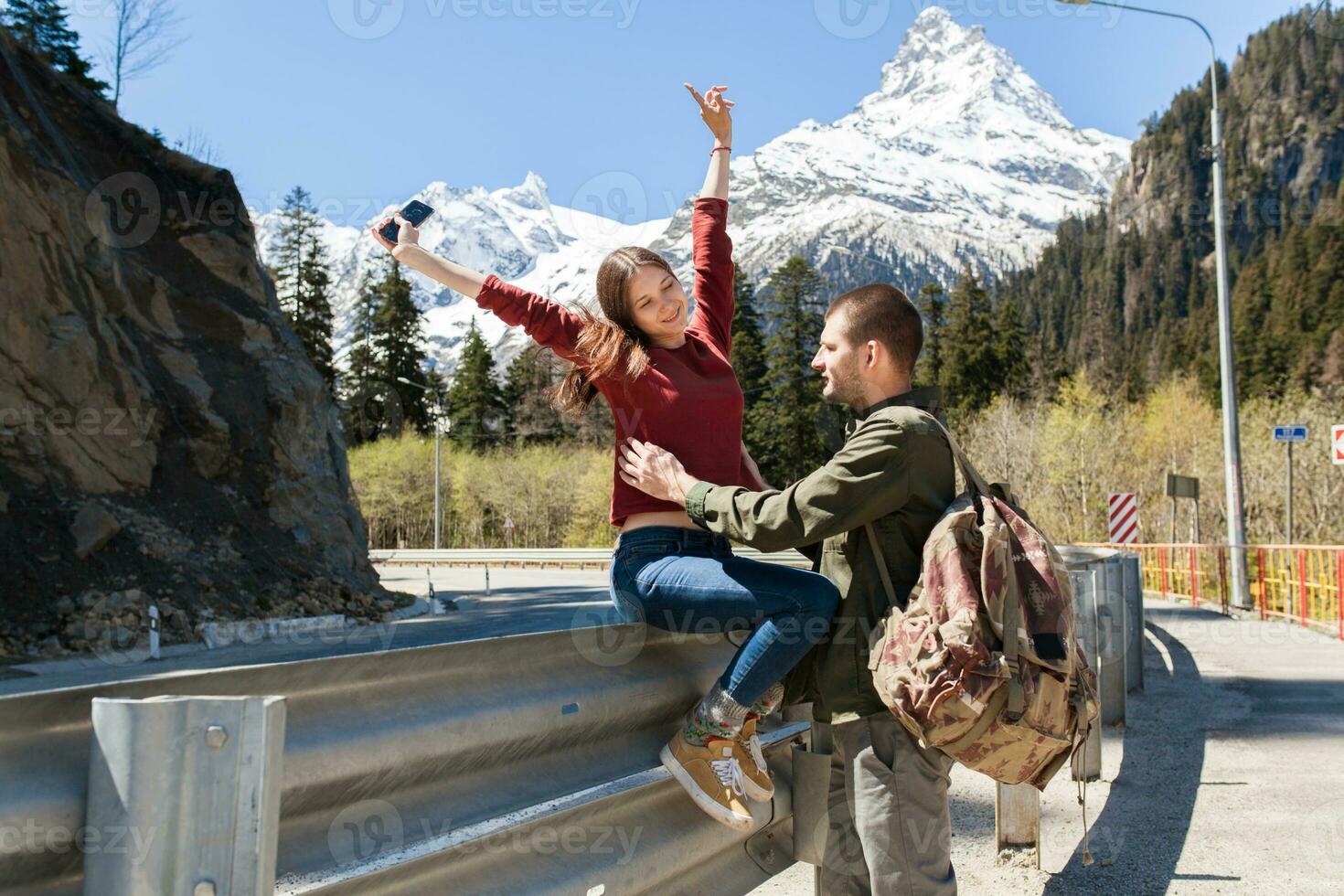 young hipster couple in love walking in mountains photo