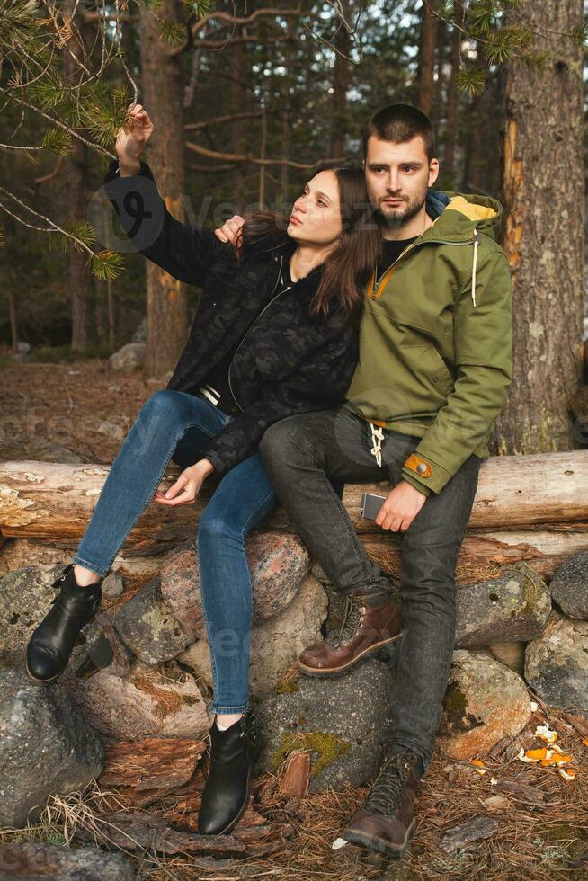 young beautiful hipster couple hiking in mountains photo