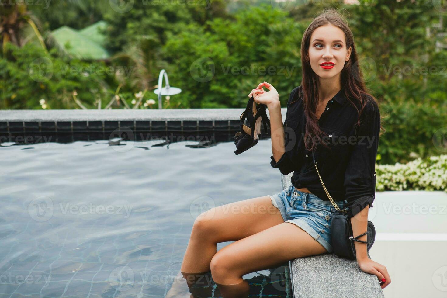 young stylish hipster woman, sitting at pool photo