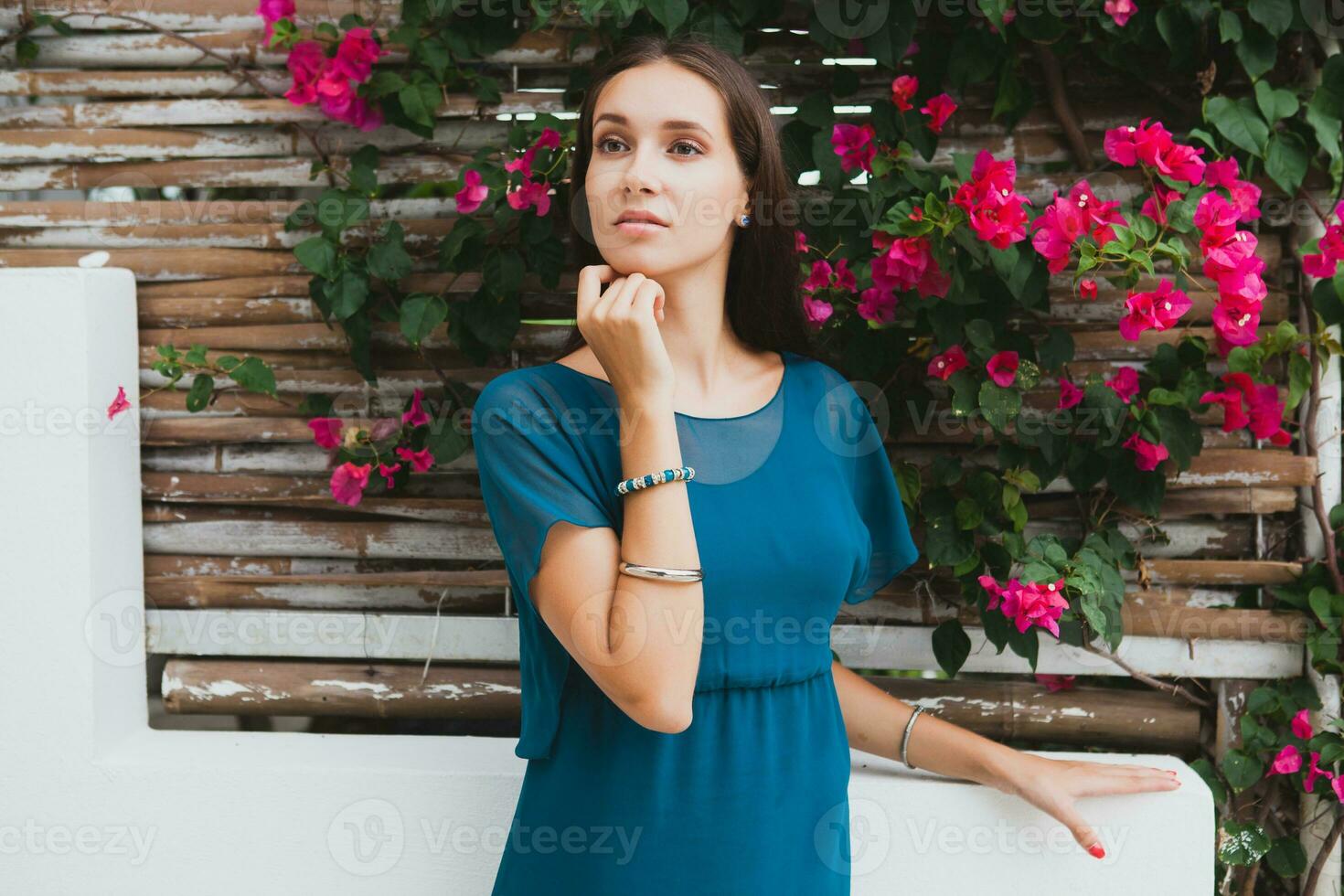 young stylish beautiful woman in blue dress, summer fashion trend, vacation, garden, tropical hotel terrace, smiling photo