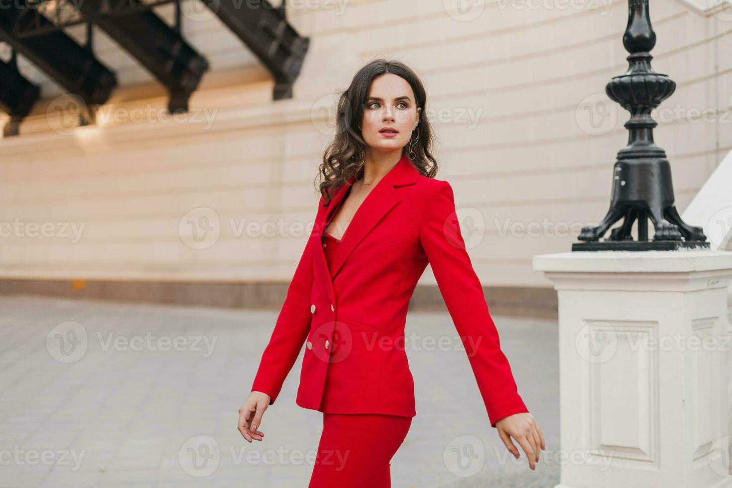 beautiful sexy rich business woman in red suit walking in city street, spring summer fashion trend photo