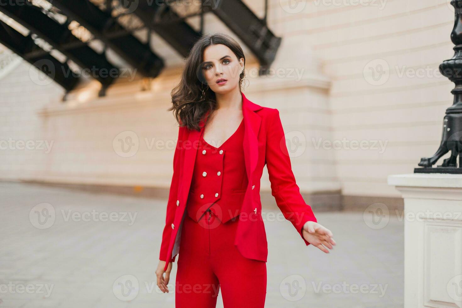 beautiful sexy rich business woman in red suit walking in city street, spring summer fashion trend photo