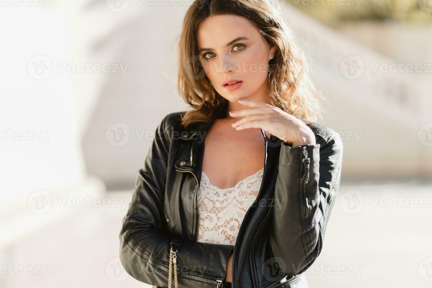 attractive woman walking in street in fashionable outfit photo