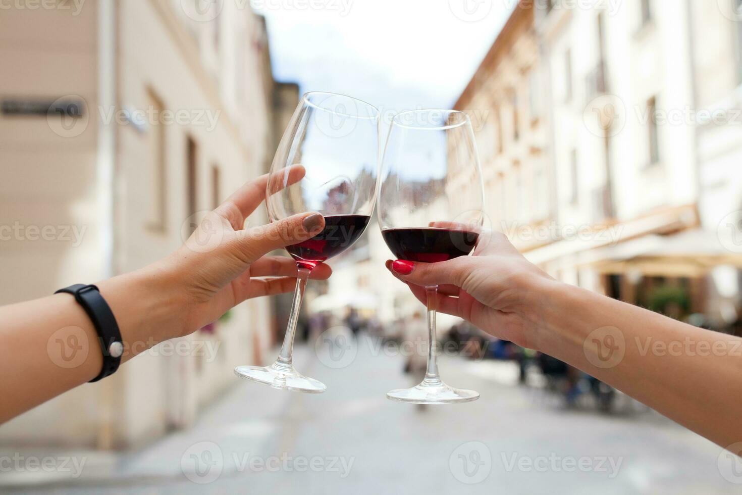 hands close up of couple toasting glasses of wine photo