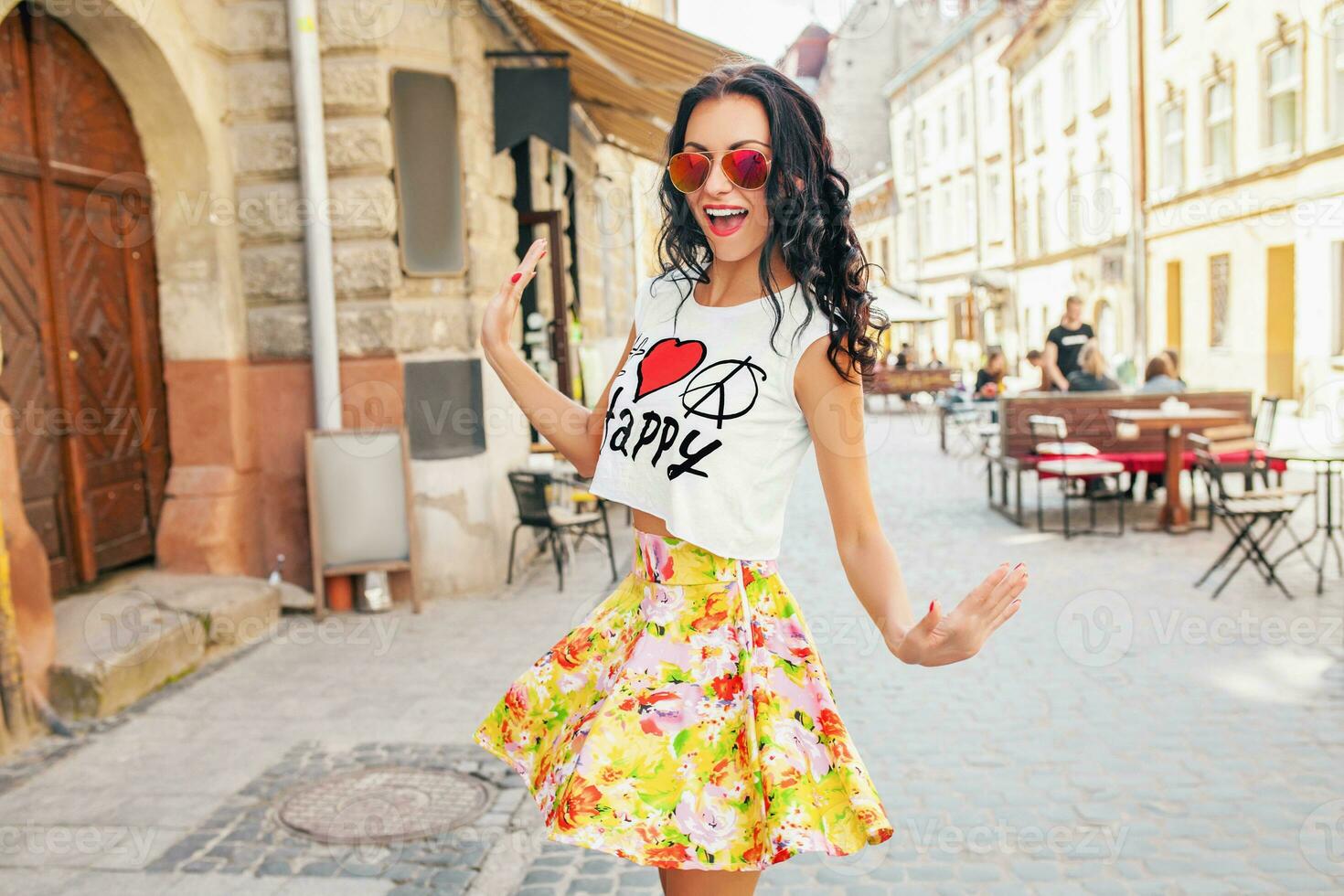 young beautiful hipster woman walking on old city street photo