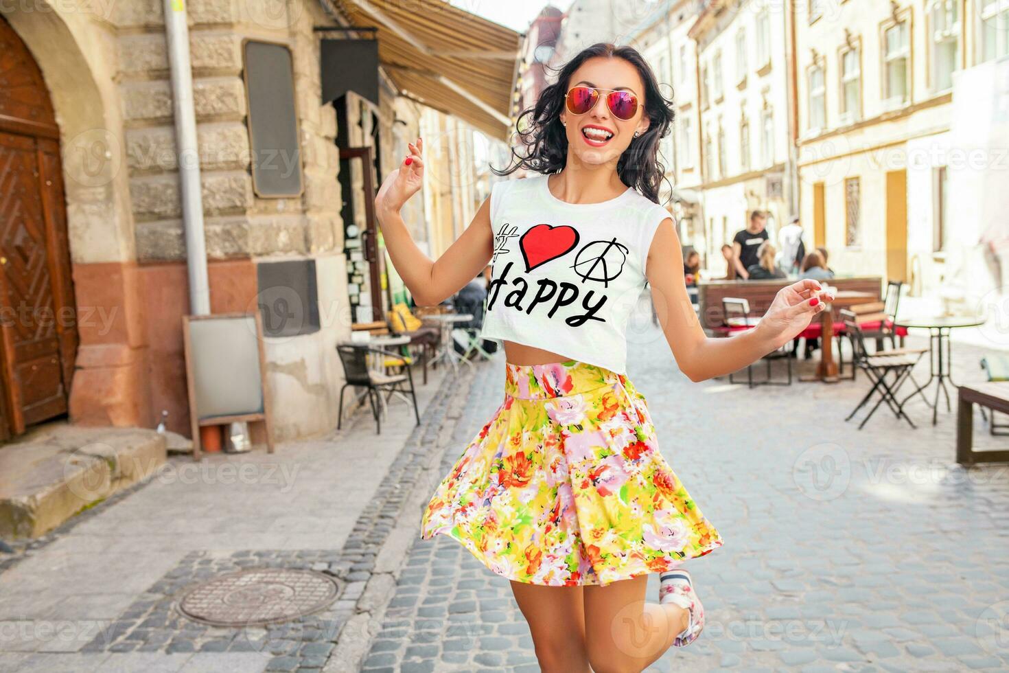 young beautiful hipster woman walking on old city street photo