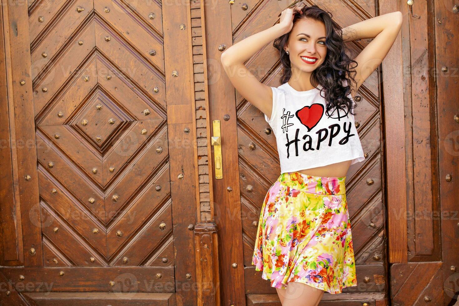 young beautiful hipster woman walking on old city street photo