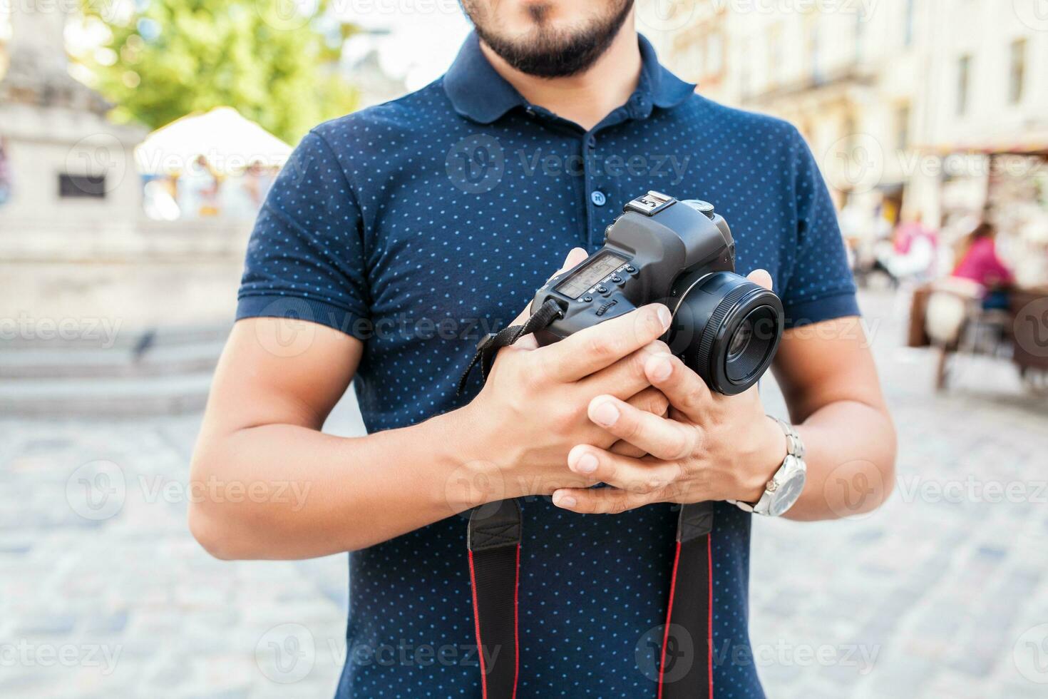 young handsome hipster man walking with photo camera