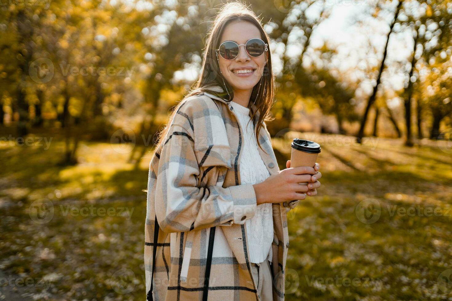 attractive young woman walking in autumn wearing jacket photo