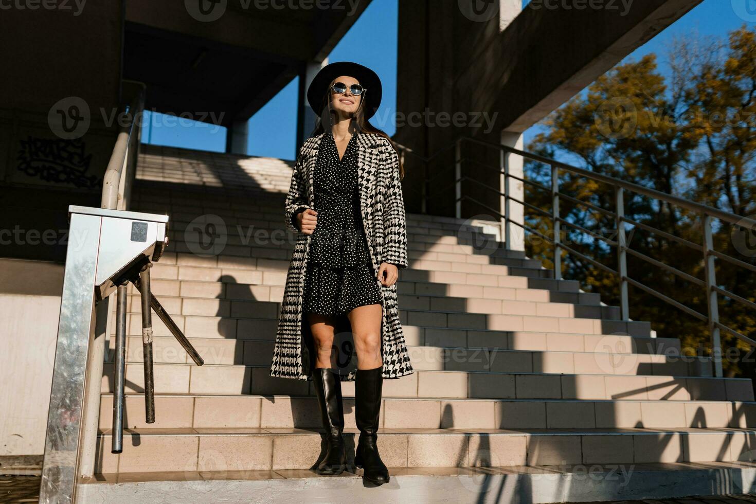 attractive young woman walking in autumn wearing coat photo