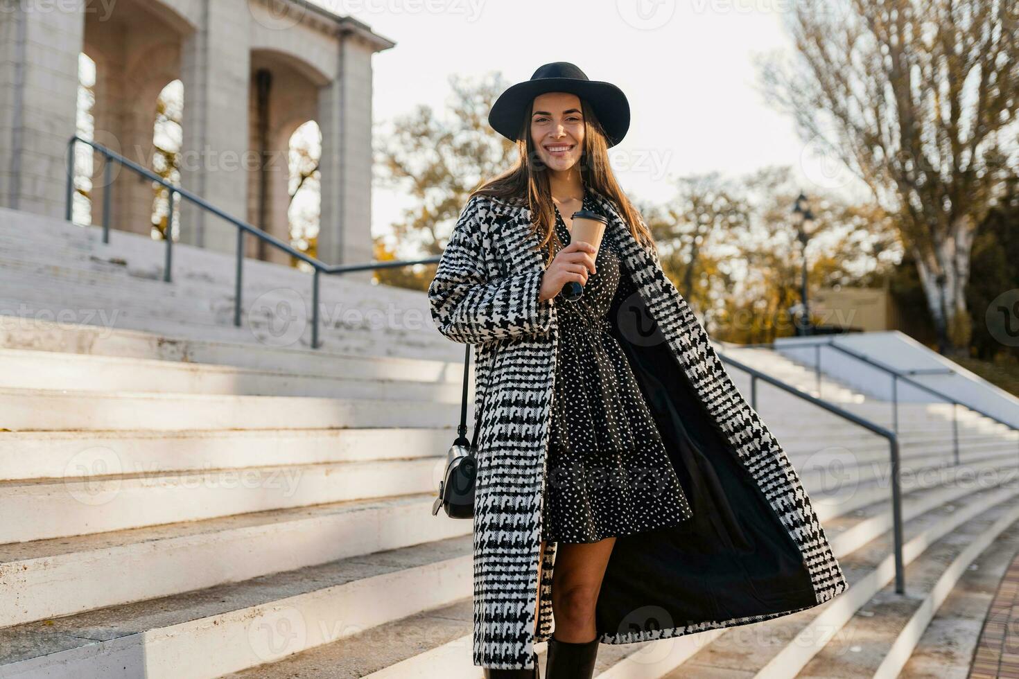 attractive young woman walking in autumn wearing coat photo