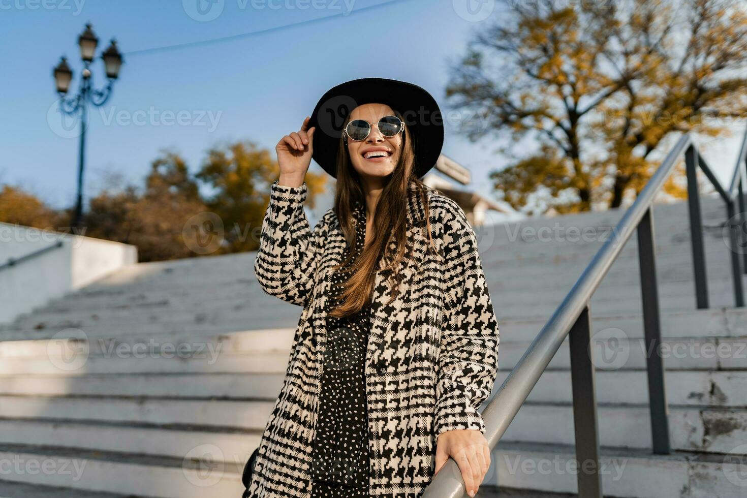 attractive young woman walking in autumn wearing coat photo