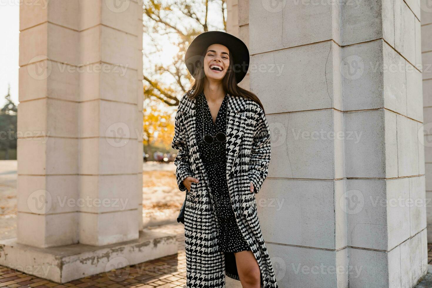 attractive young woman walking in autumn wearing coat photo