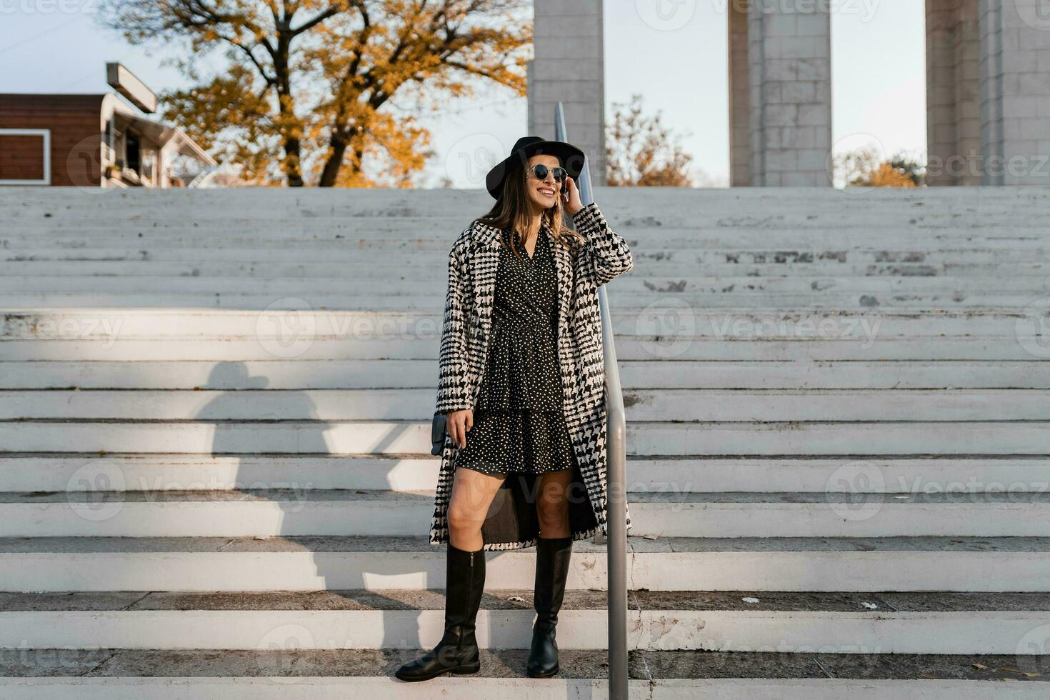 attractive young woman walking in autumn wearing coat photo