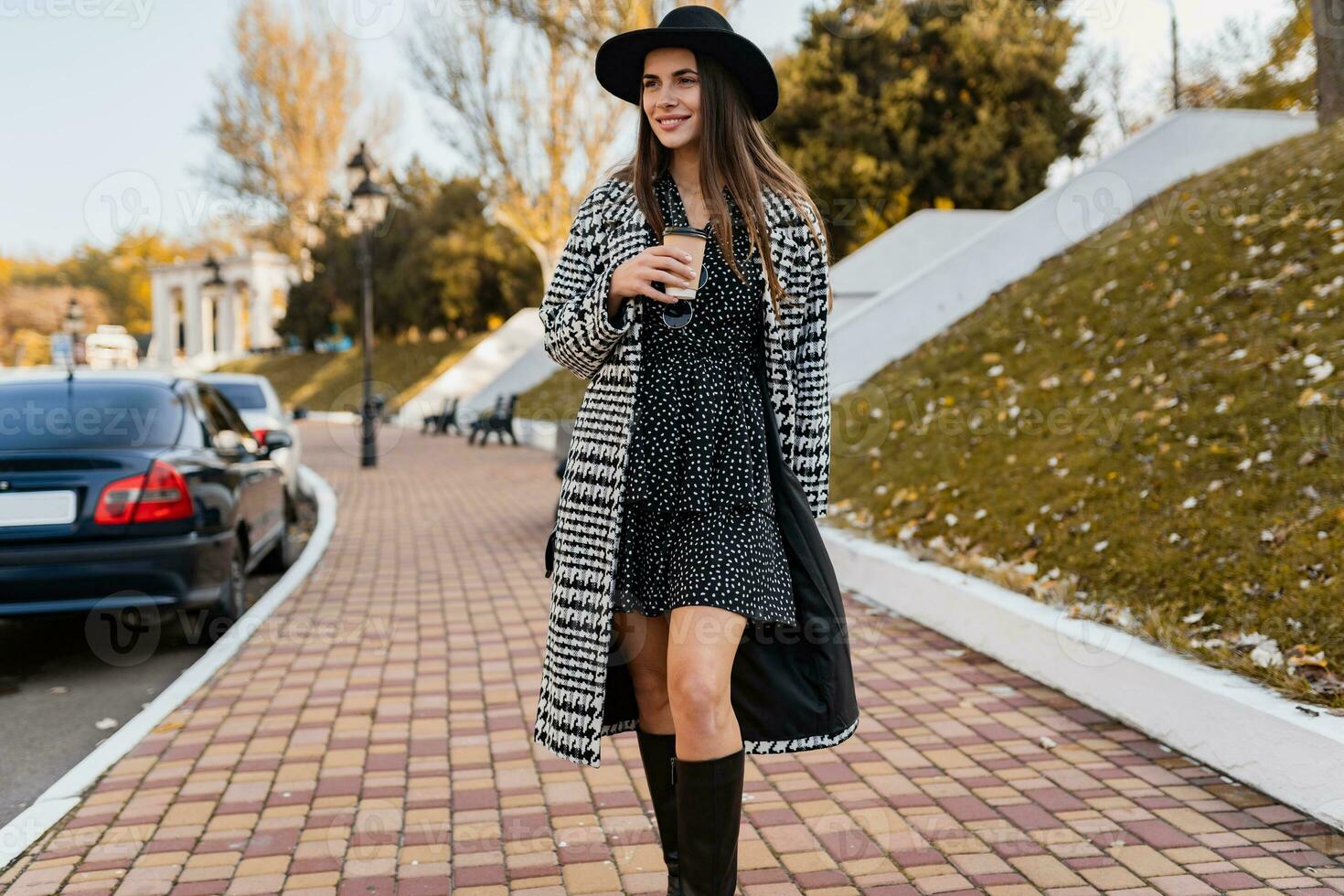 attractive young woman walking in autumn wearing coat photo