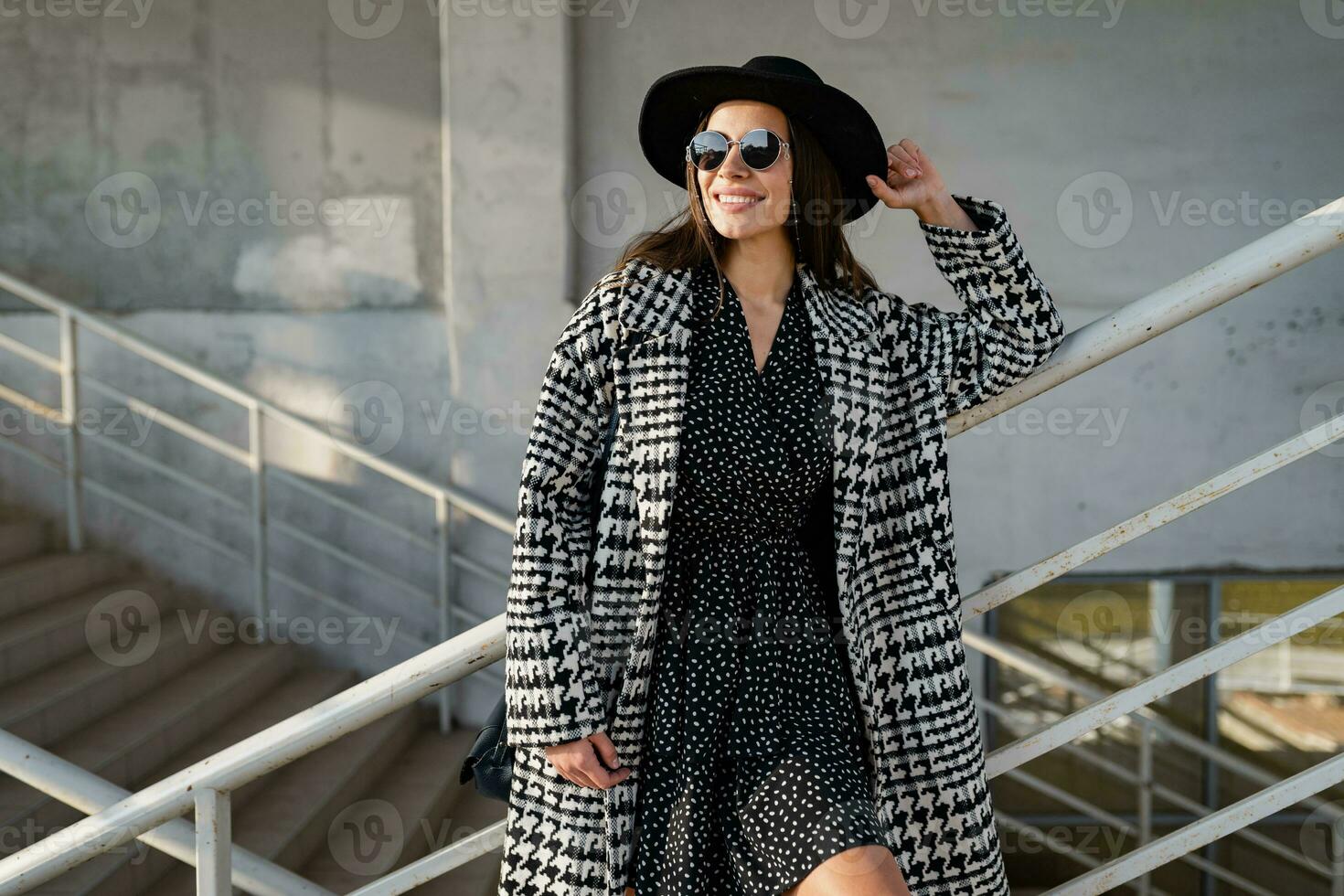 attractive young woman walking in autumn wearing coat photo
