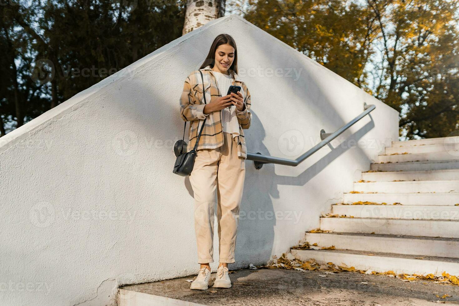 attractive young woman walking in autumn wearing jacket photo