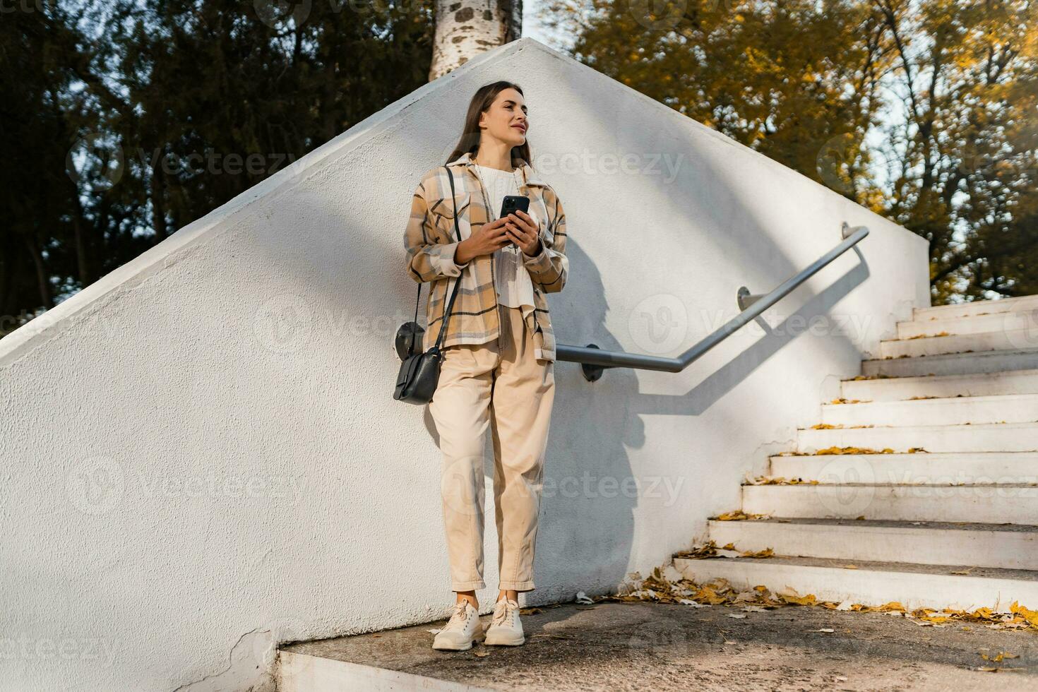 attractive young woman walking in autumn wearing jacket photo