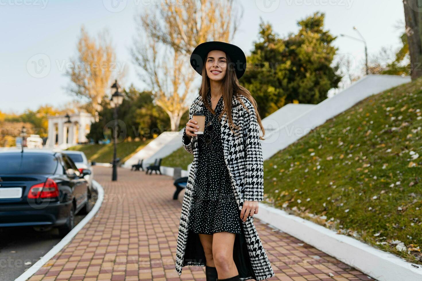 attractive young woman walking in autumn wearing coat photo