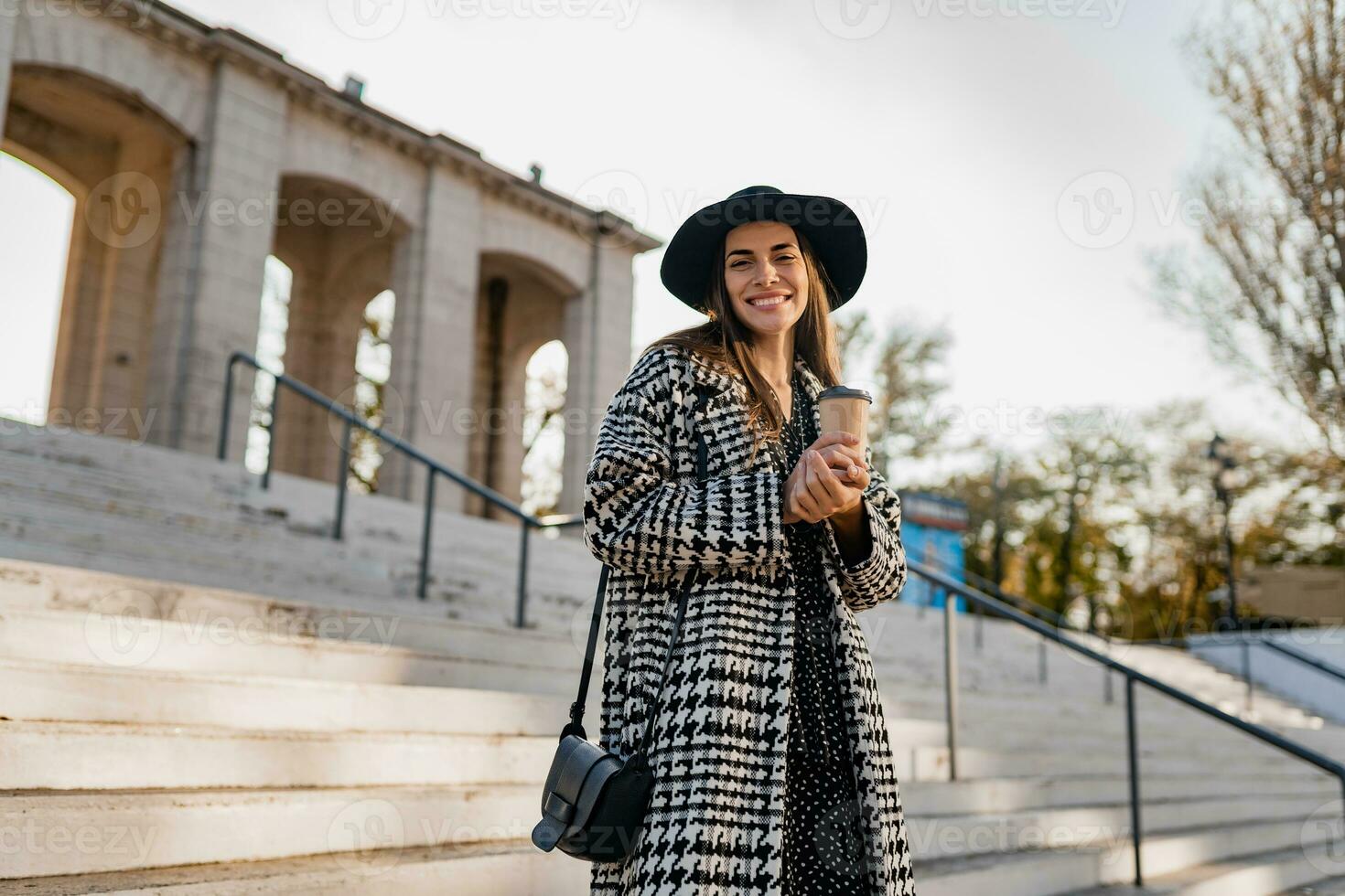 attractive young woman walking in autumn wearing coat photo