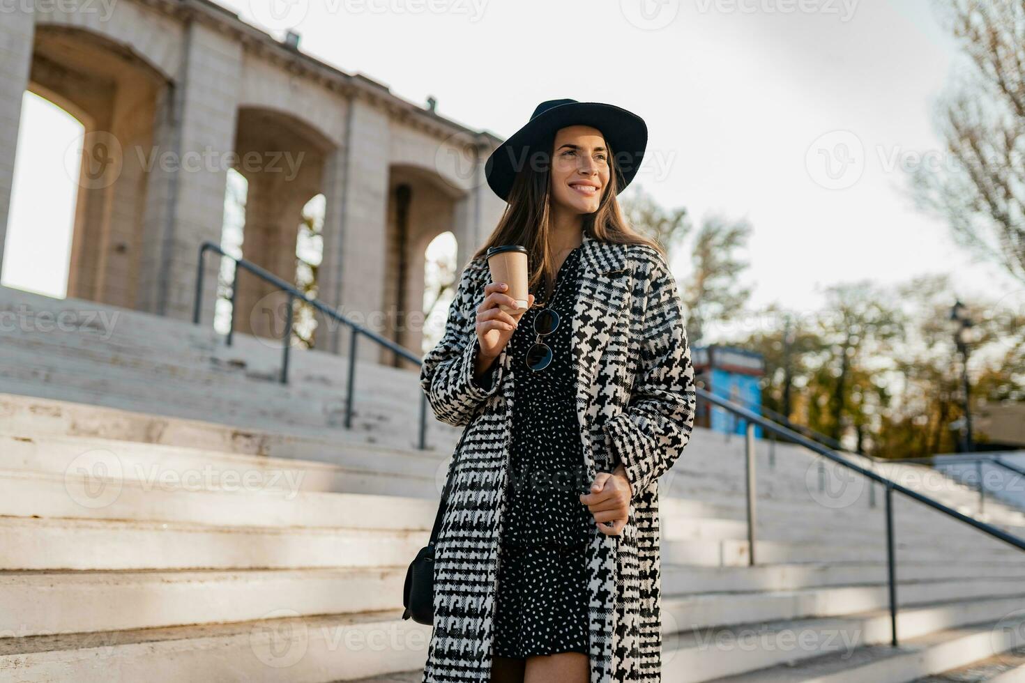 attractive young woman walking in autumn wearing coat photo