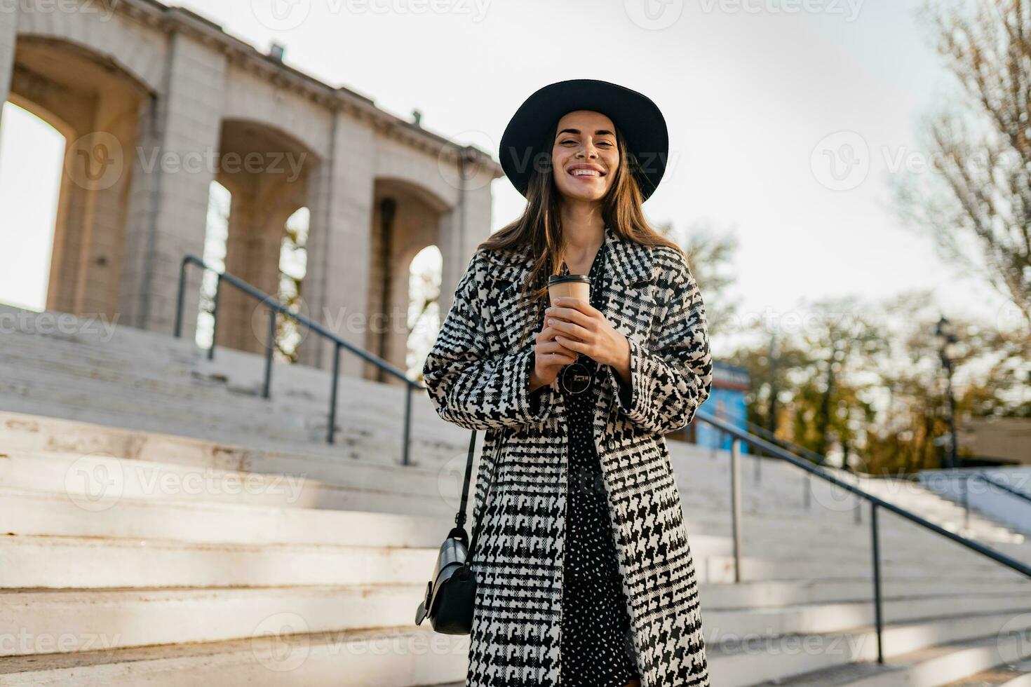 attractive young woman walking in autumn wearing coat photo