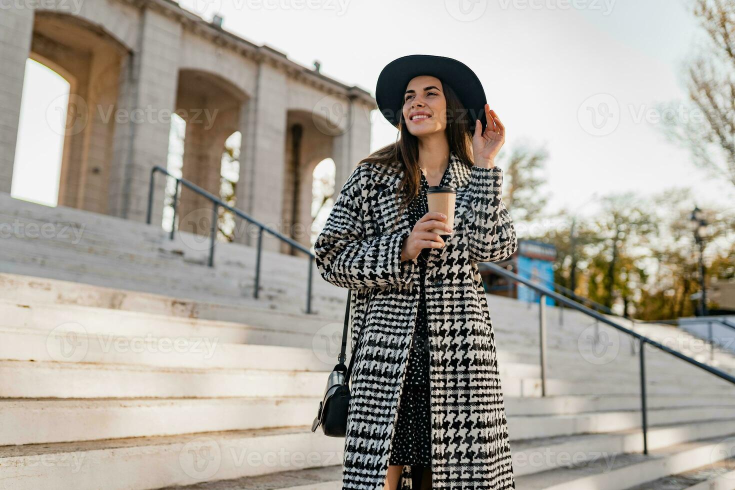 attractive young woman walking in autumn wearing coat photo