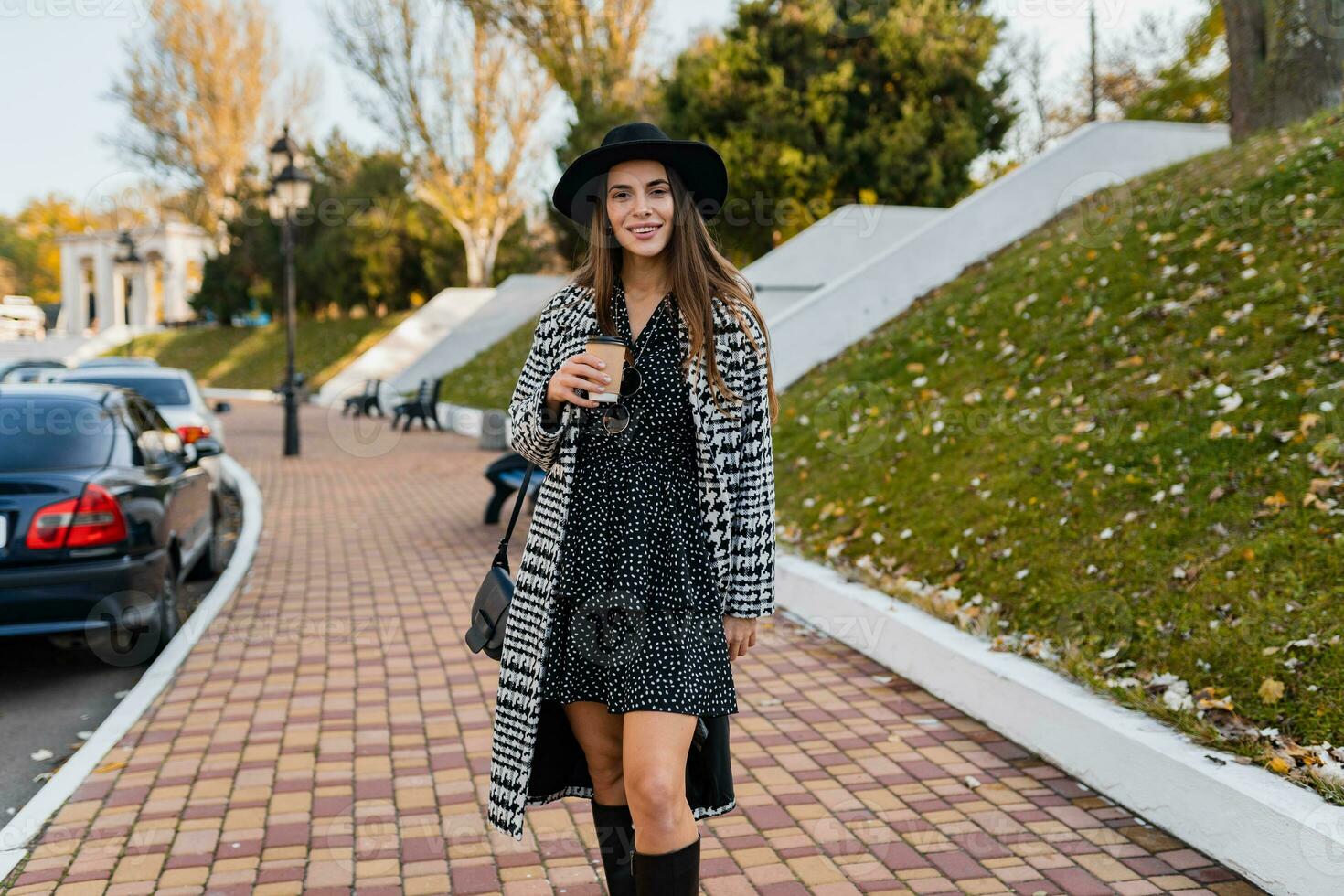 attractive young woman walking in autumn wearing coat photo