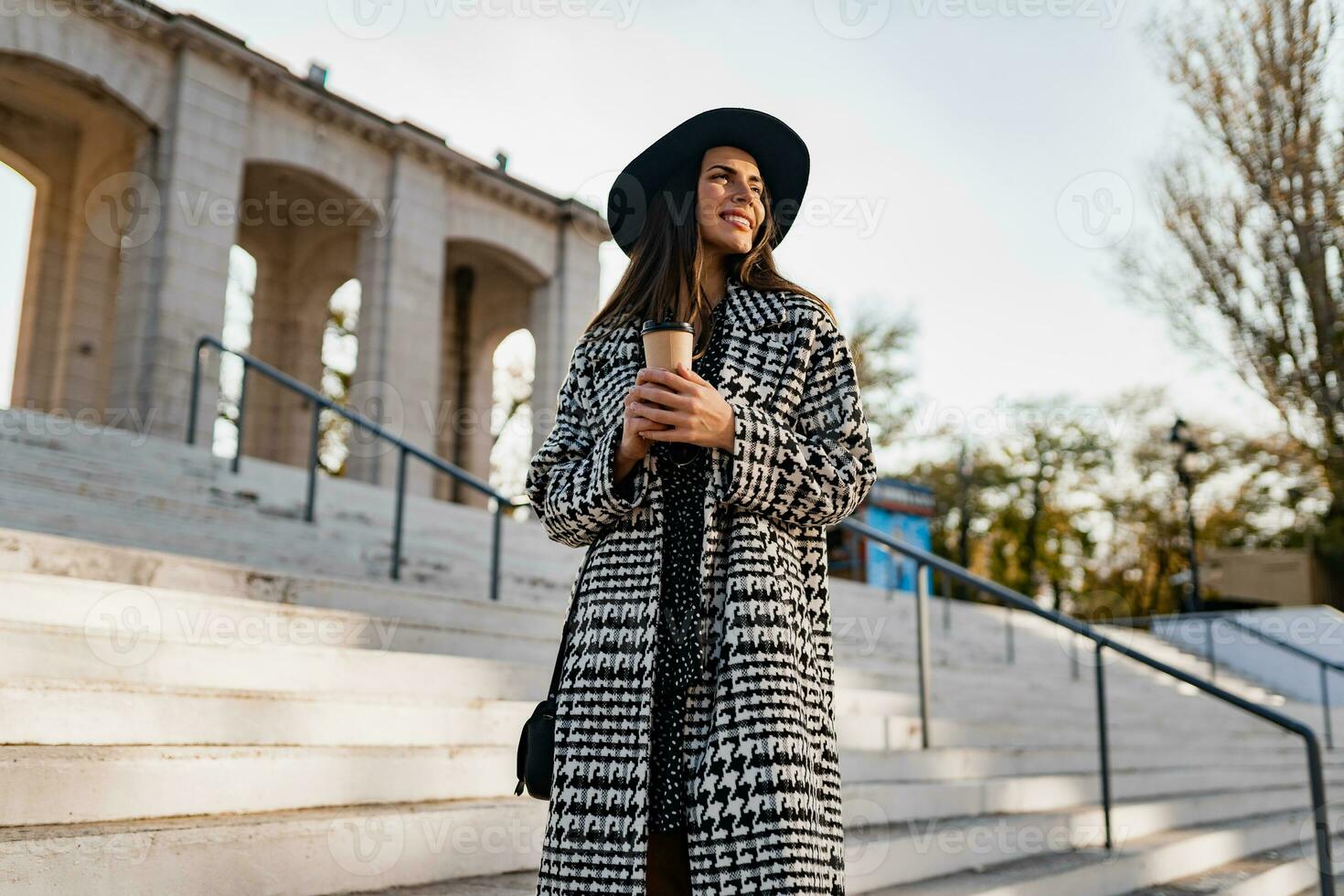 attractive young woman walking in autumn wearing coat photo