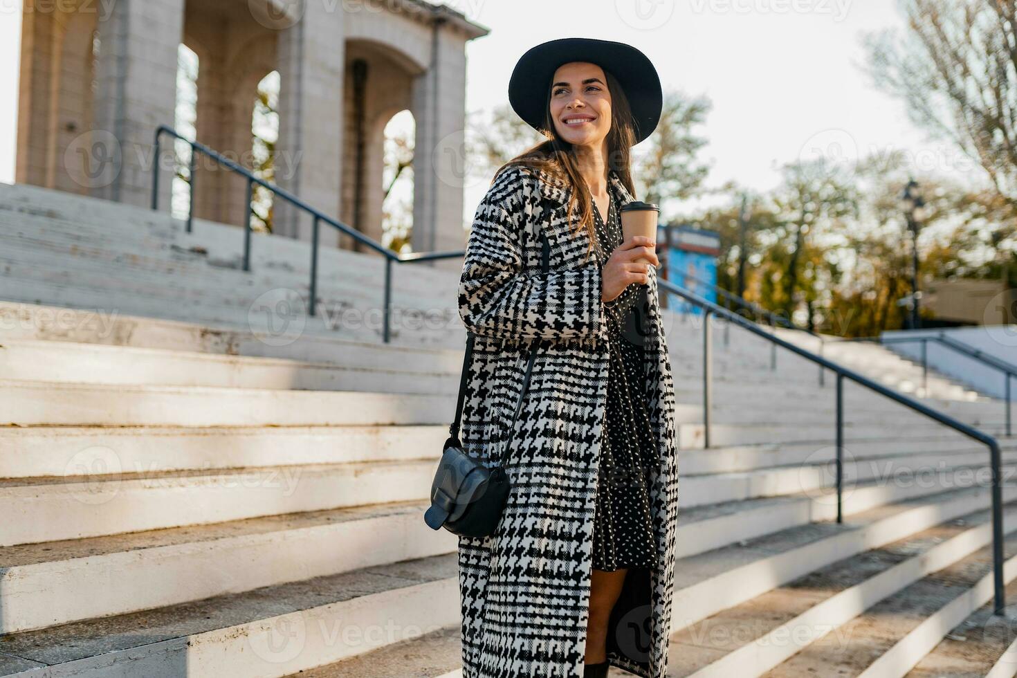 attractive young woman walking in autumn wearing coat photo