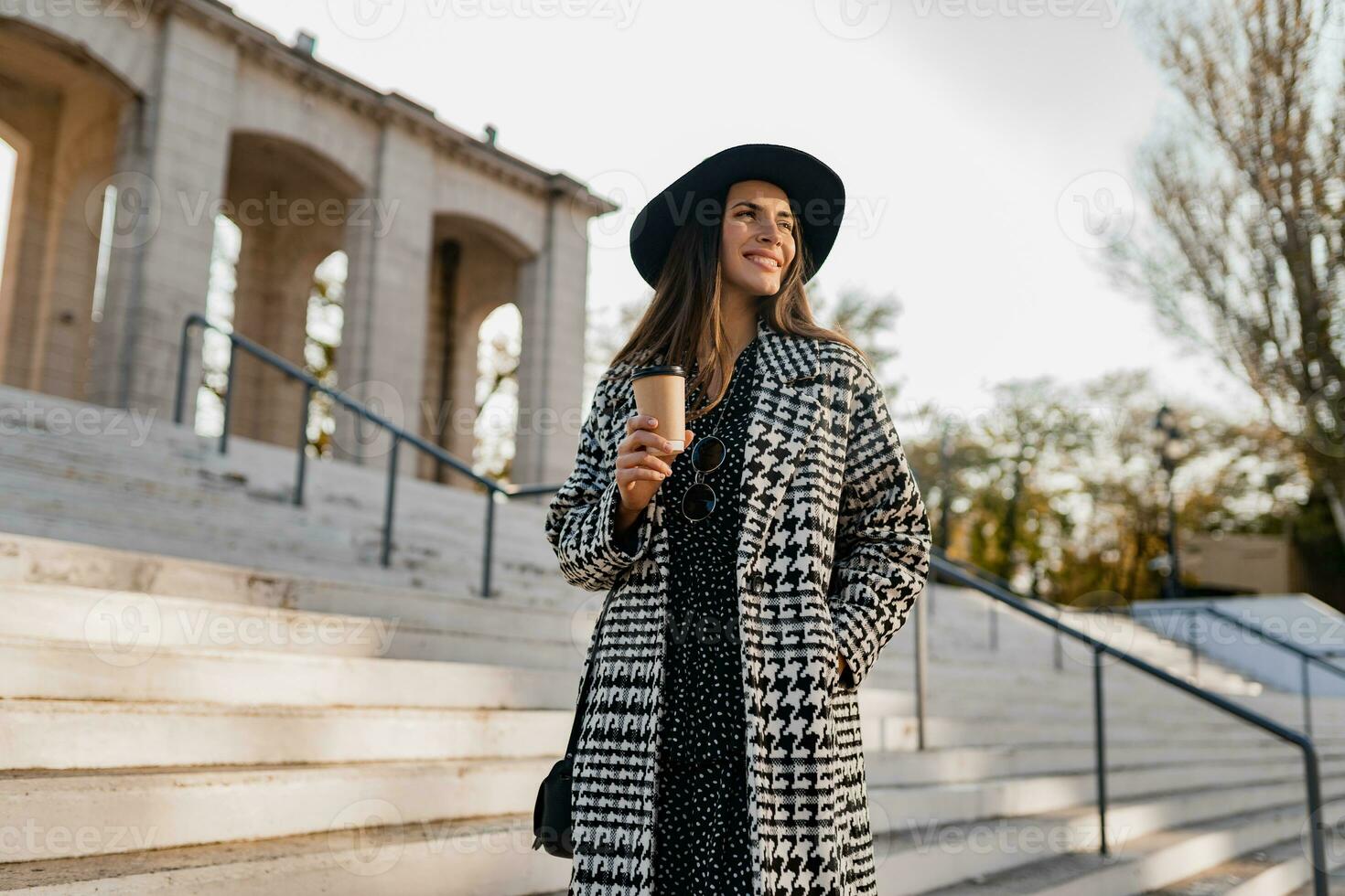 attractive young woman walking in autumn wearing coat photo