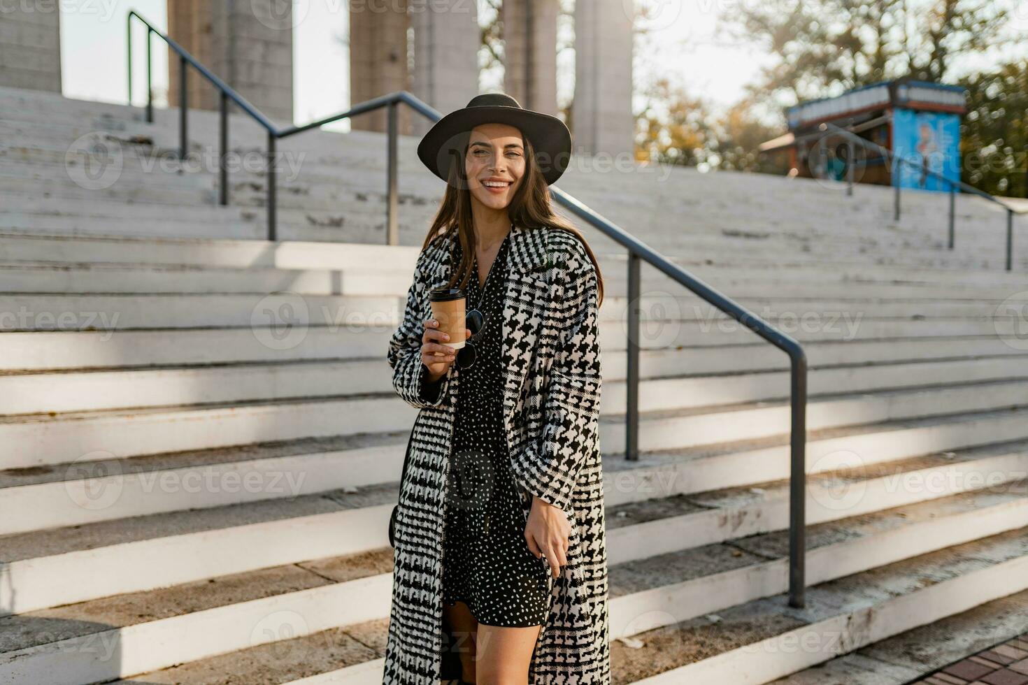 attractive young woman walking in autumn wearing coat photo