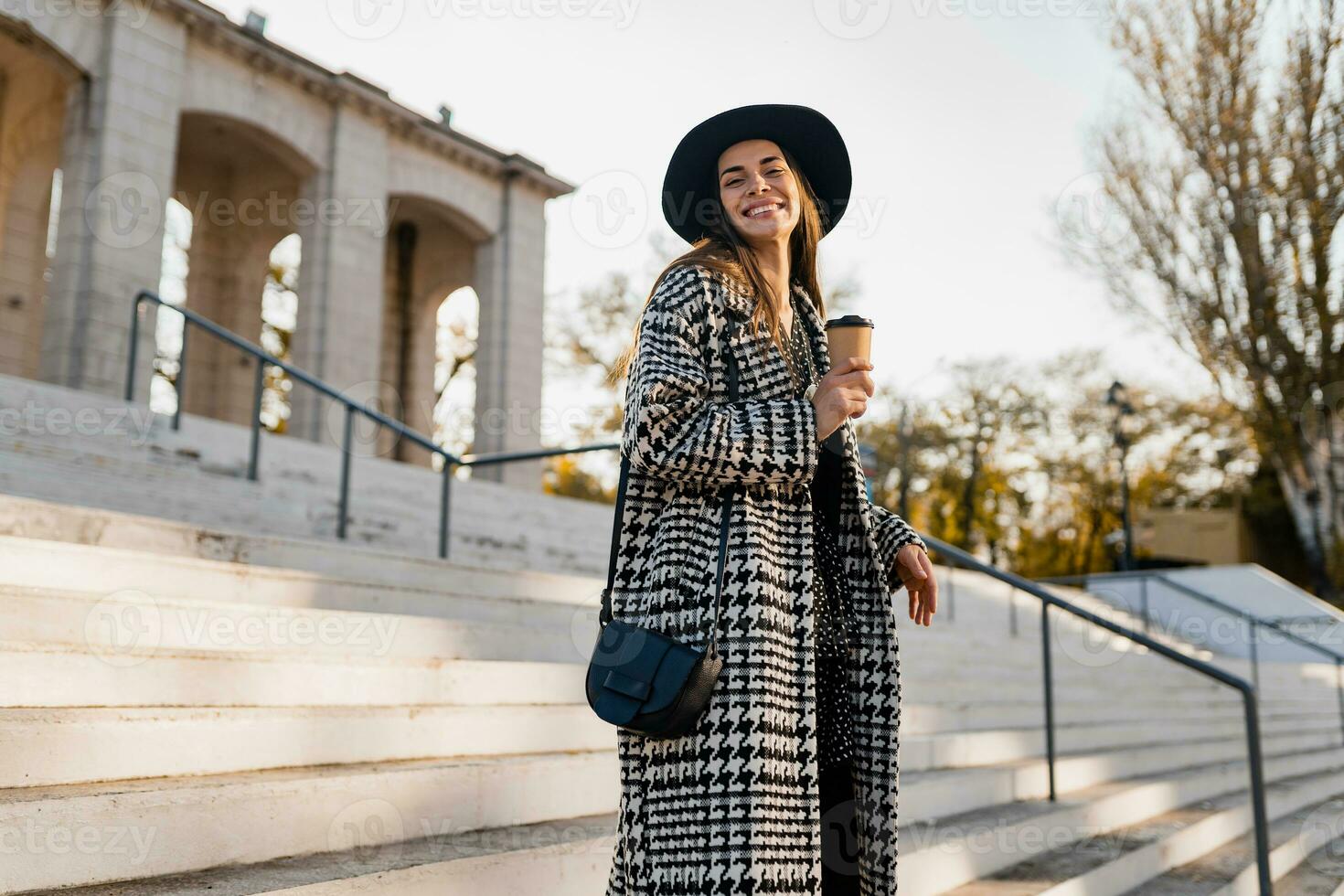attractive young woman walking in autumn wearing coat photo