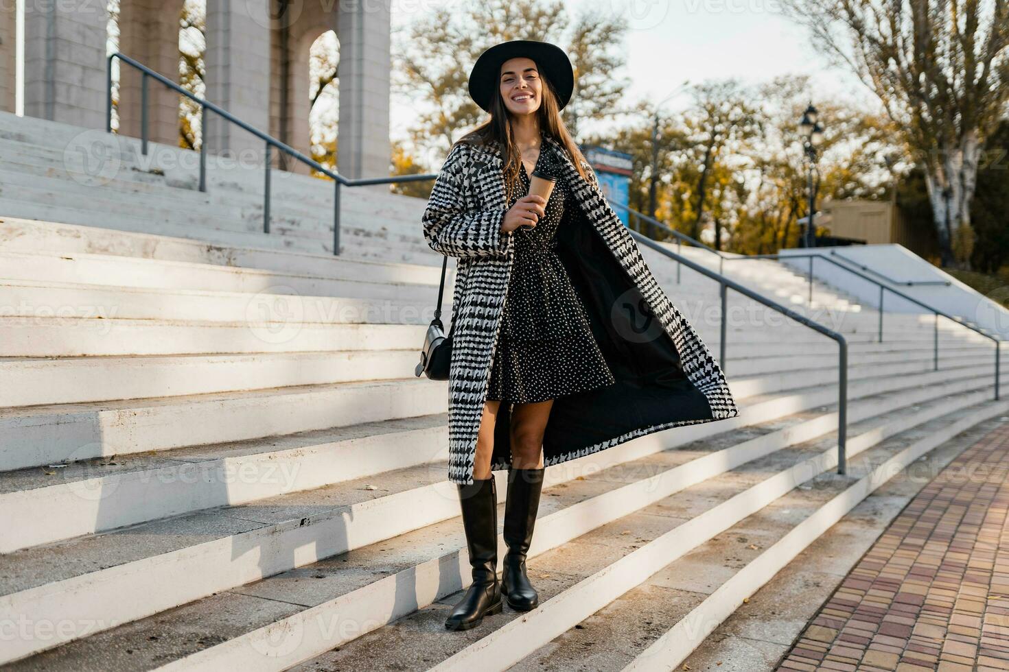 attractive young woman walking in autumn wearing coat photo