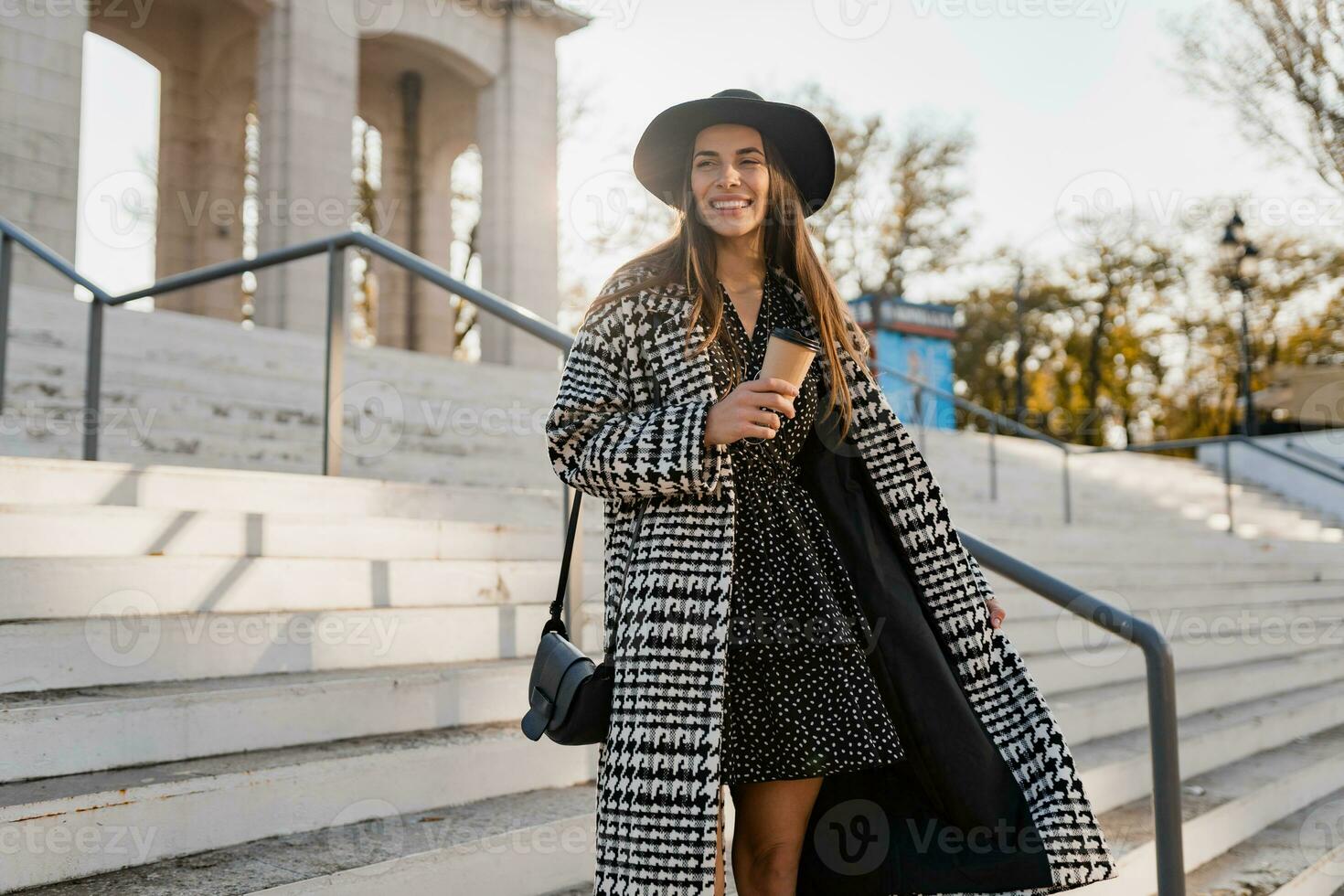 attractive young woman walking in autumn wearing coat photo