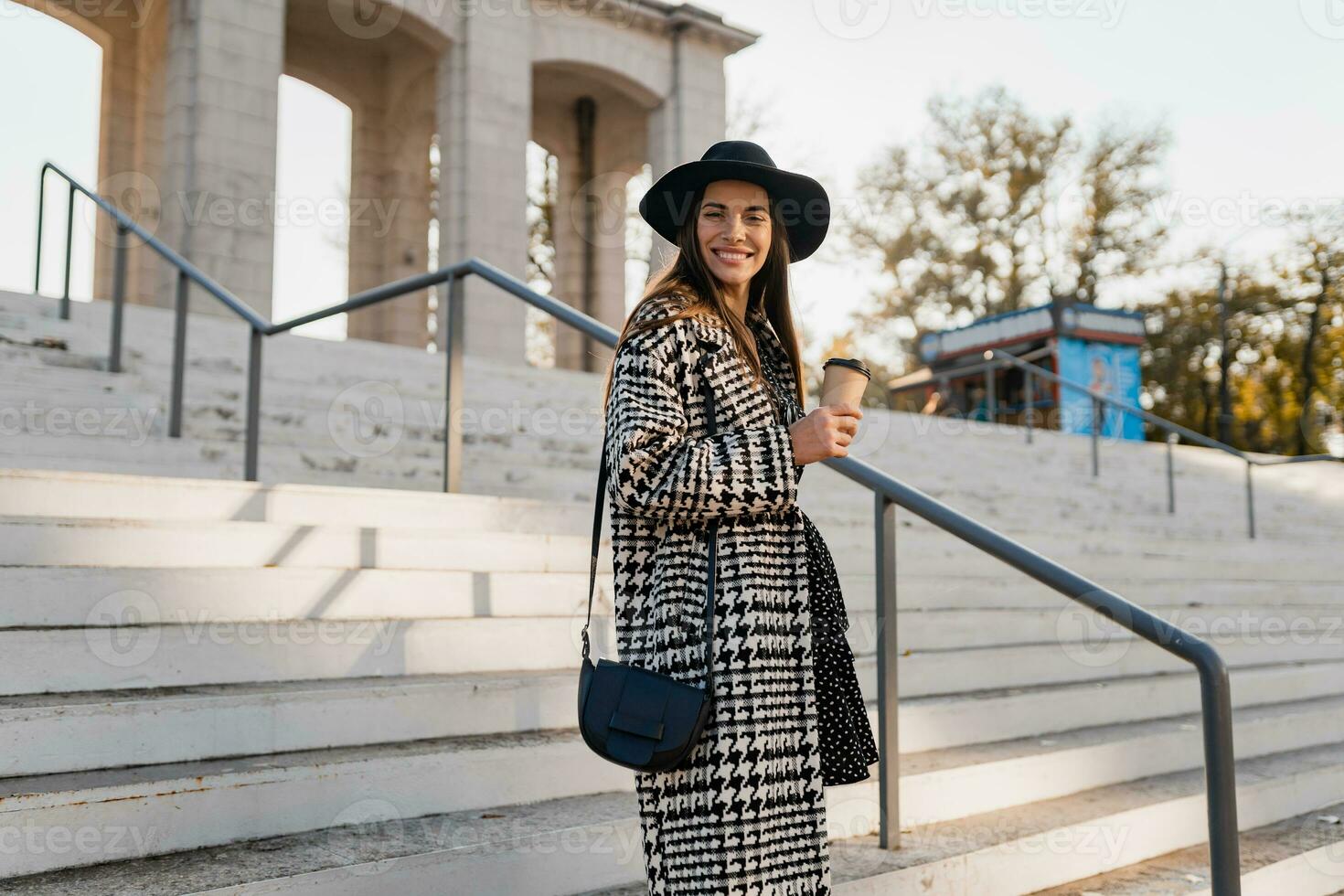 attractive young woman walking in autumn wearing coat photo