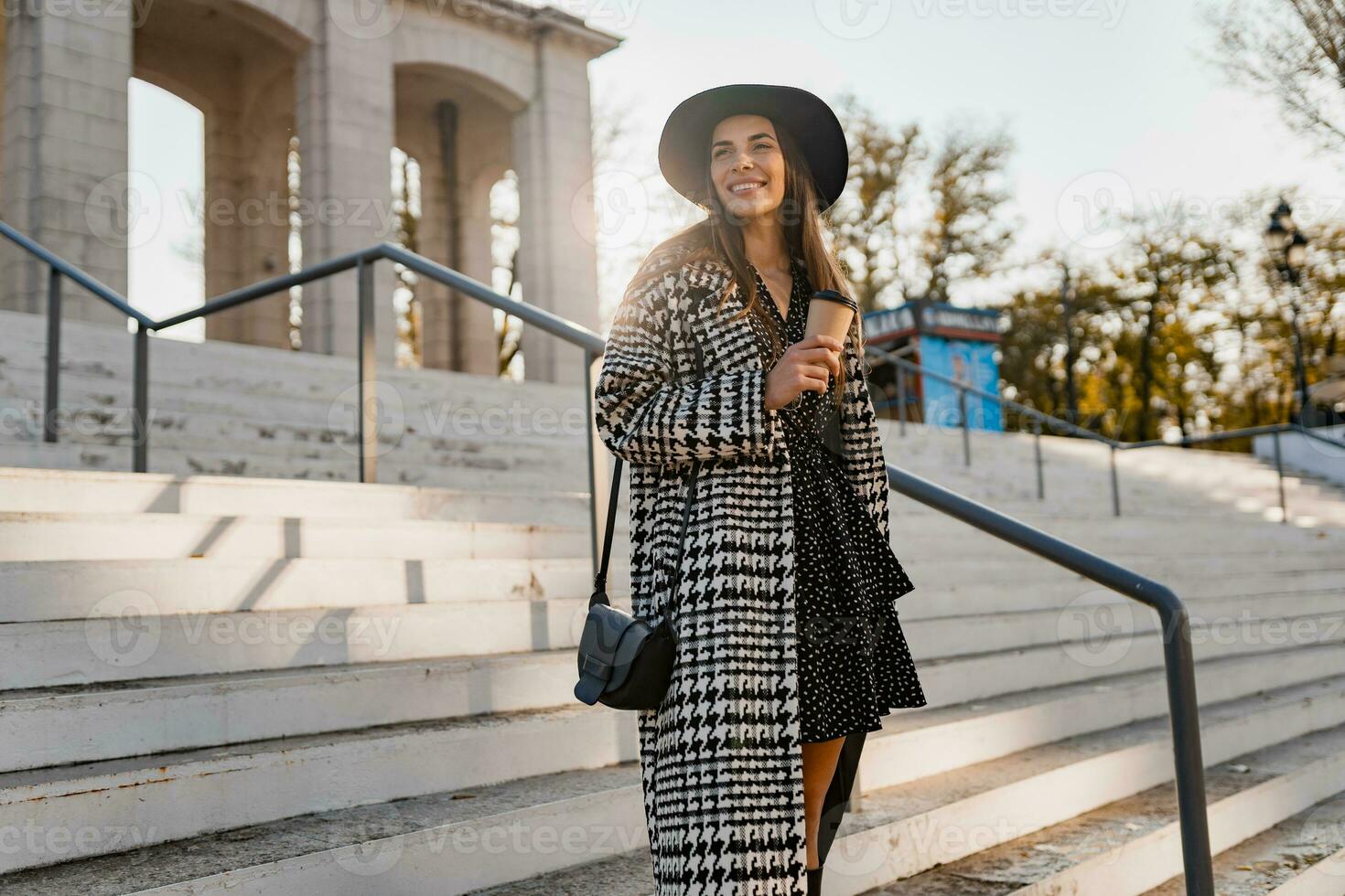 attractive young woman walking in autumn wearing coat photo