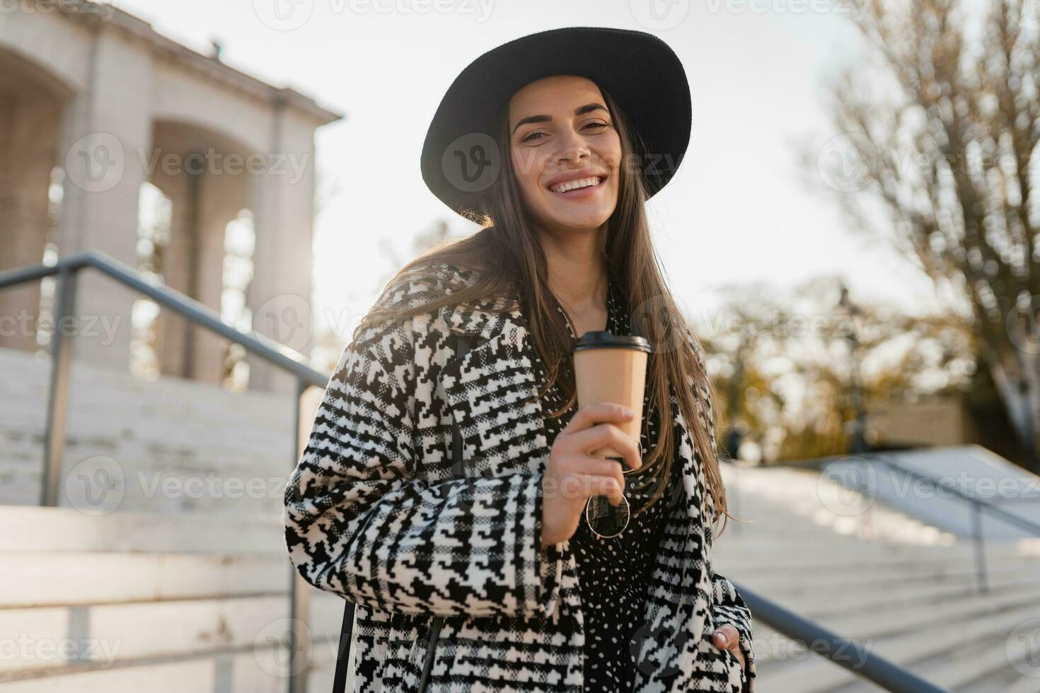 attractive young woman walking in autumn wearing coat photo