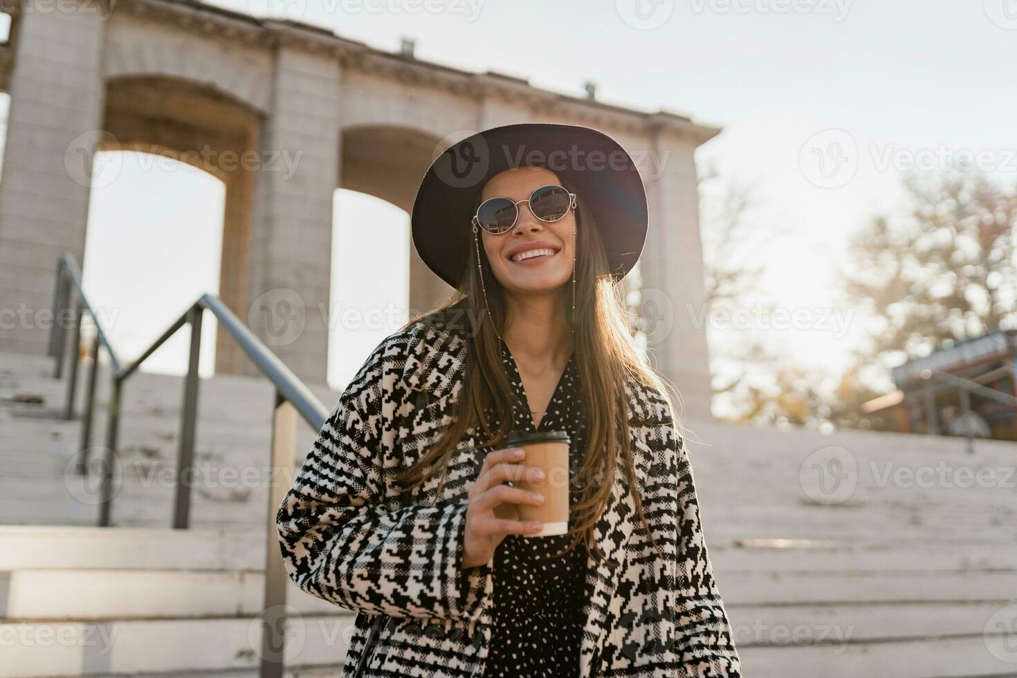 attractive young woman walking in autumn wearing coat photo