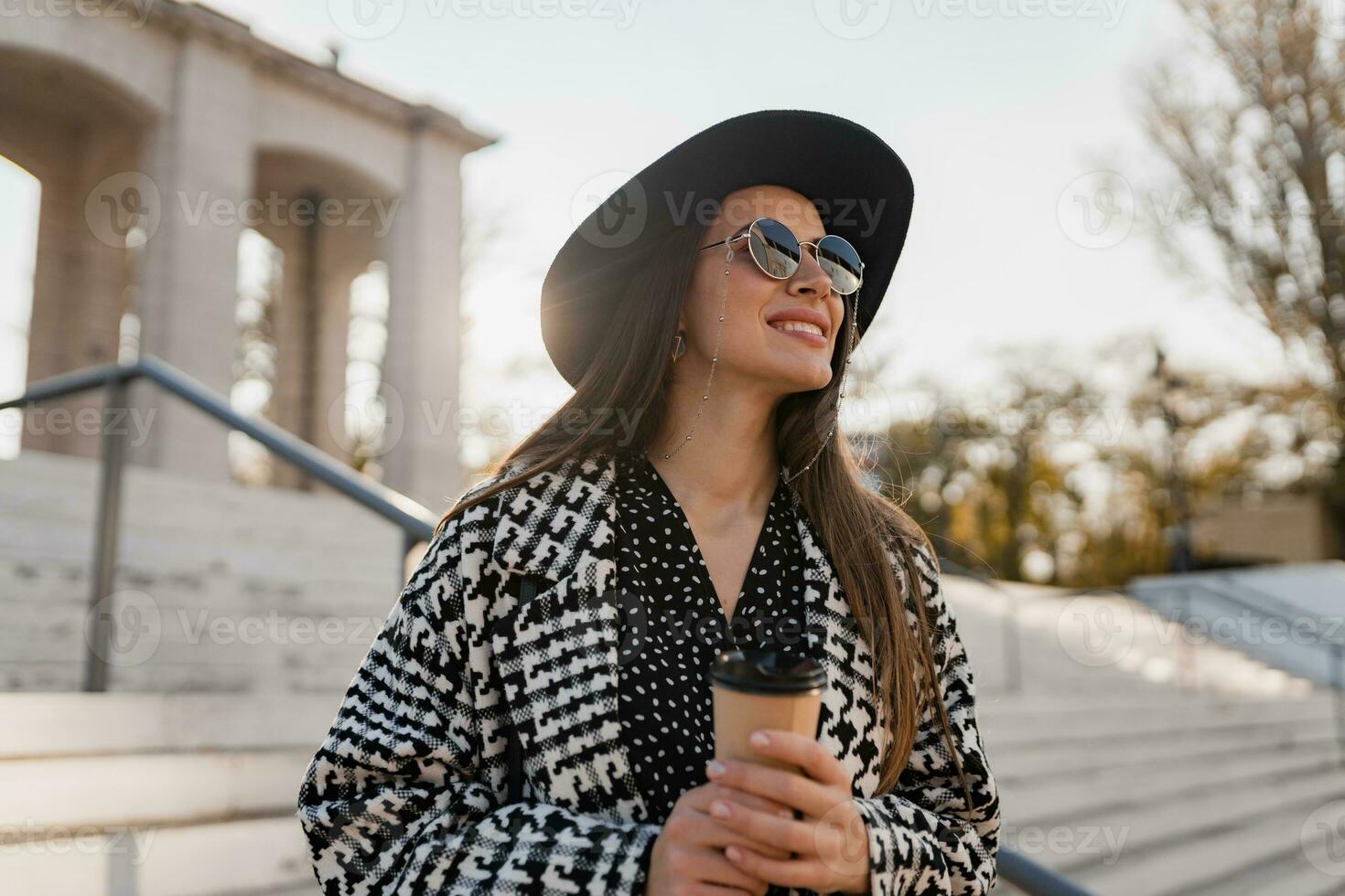 attractive young woman walking in autumn wearing coat photo