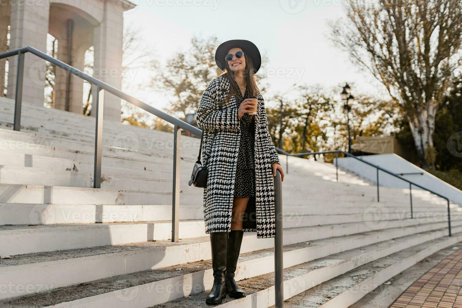 attractive young woman walking in autumn wearing coat photo
