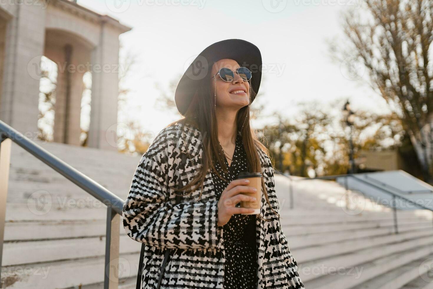 attractive young woman walking in autumn wearing coat photo