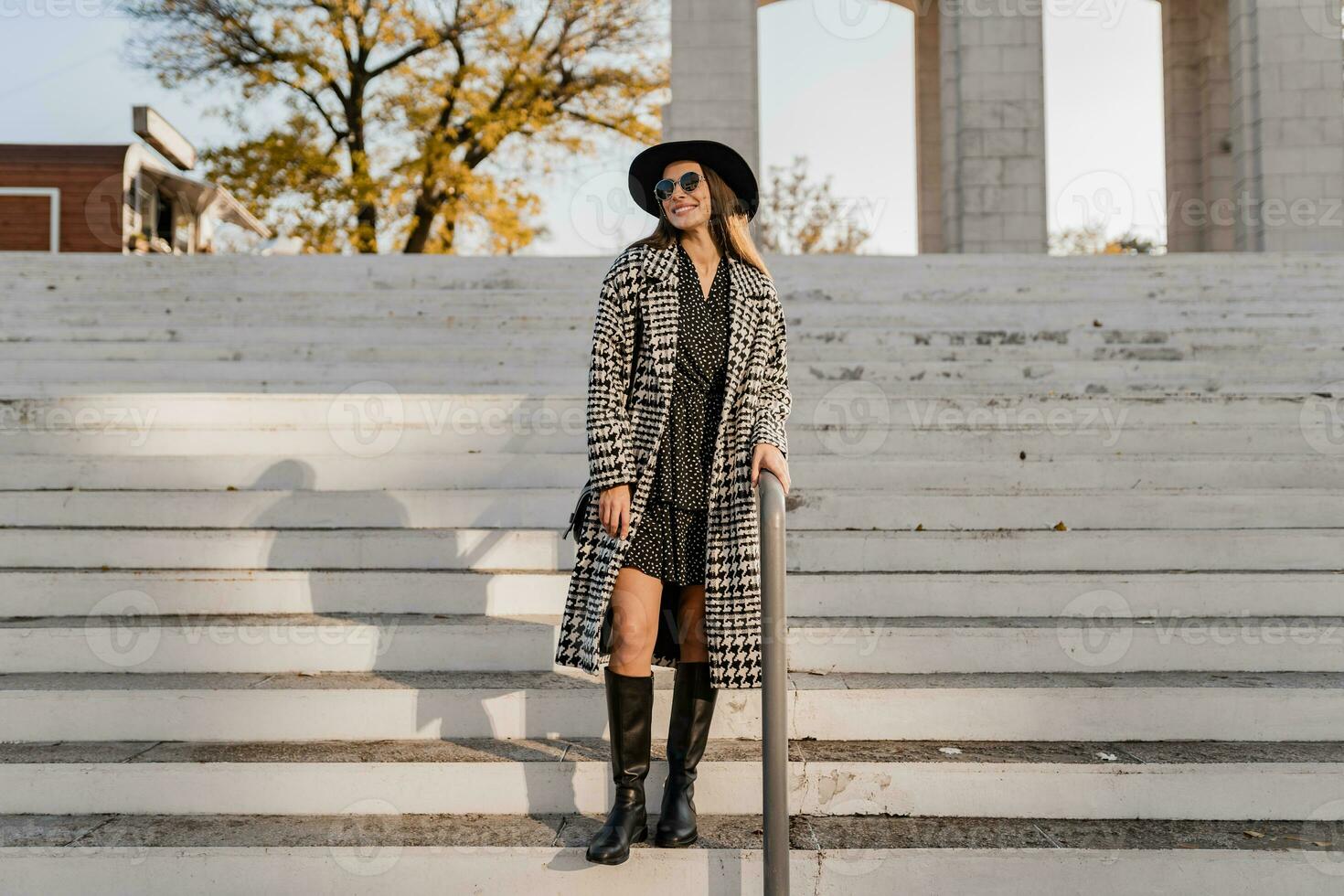 attractive young woman walking in autumn wearing coat photo