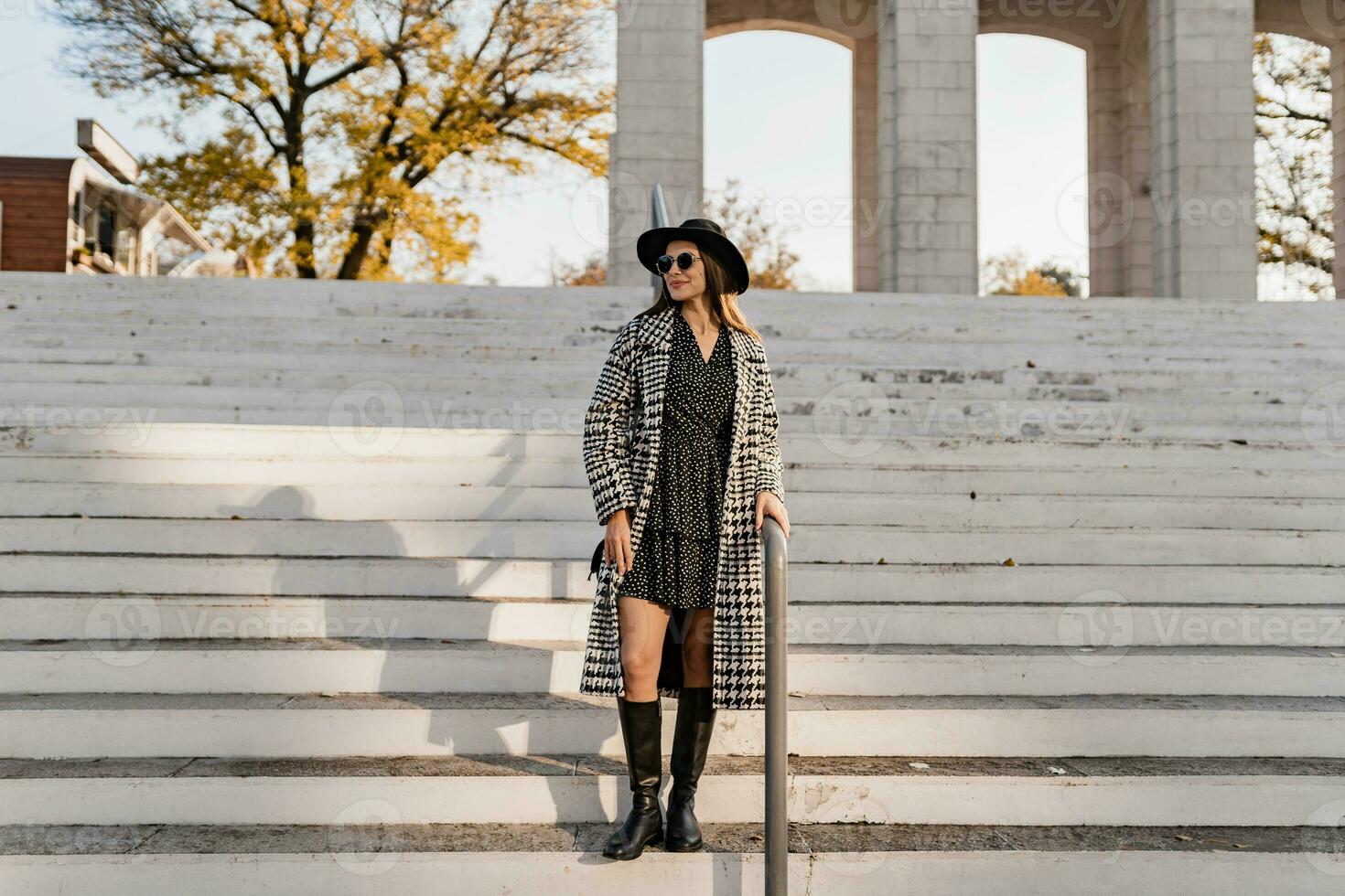 attractive young woman walking in autumn wearing coat photo