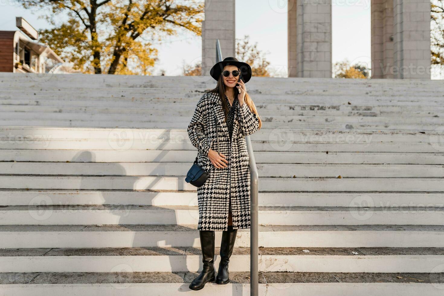 attractive young woman walking in autumn wearing coat photo