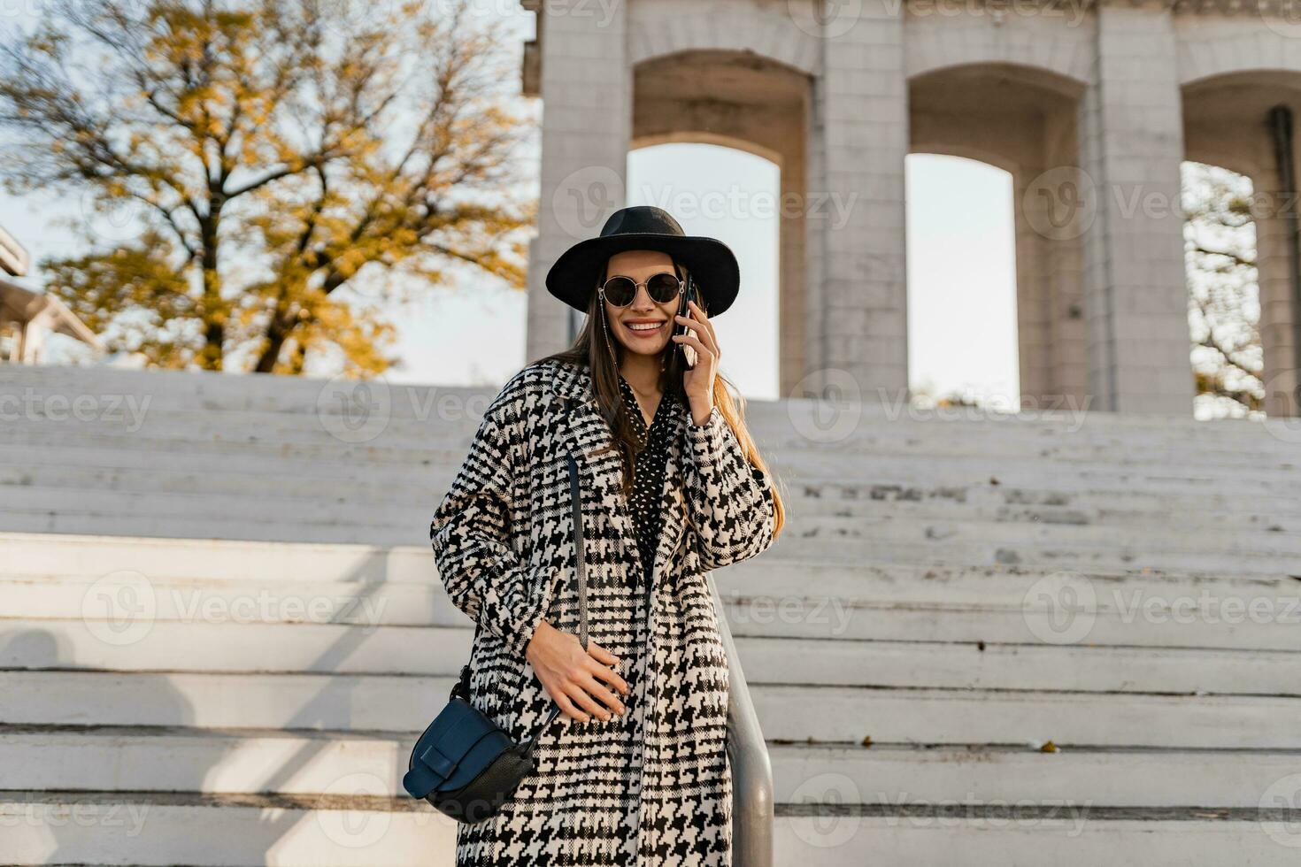 attractive young woman walking in autumn wearing coat photo