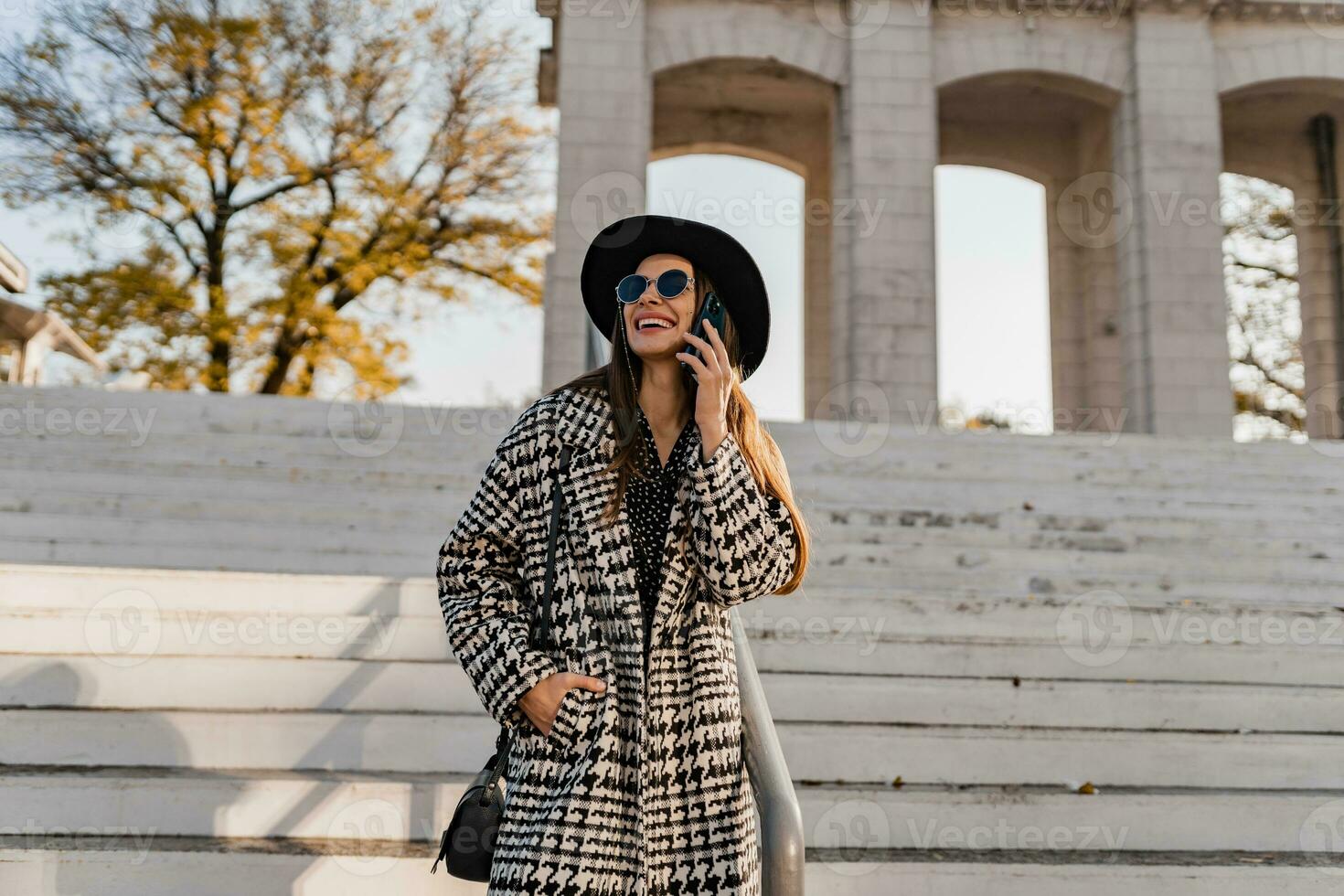 attractive young woman walking in autumn wearing coat photo
