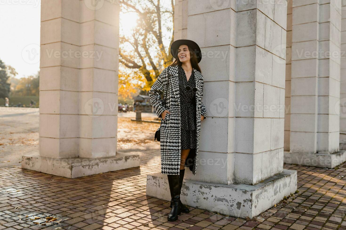 attractive young woman walking in autumn wearing coat photo