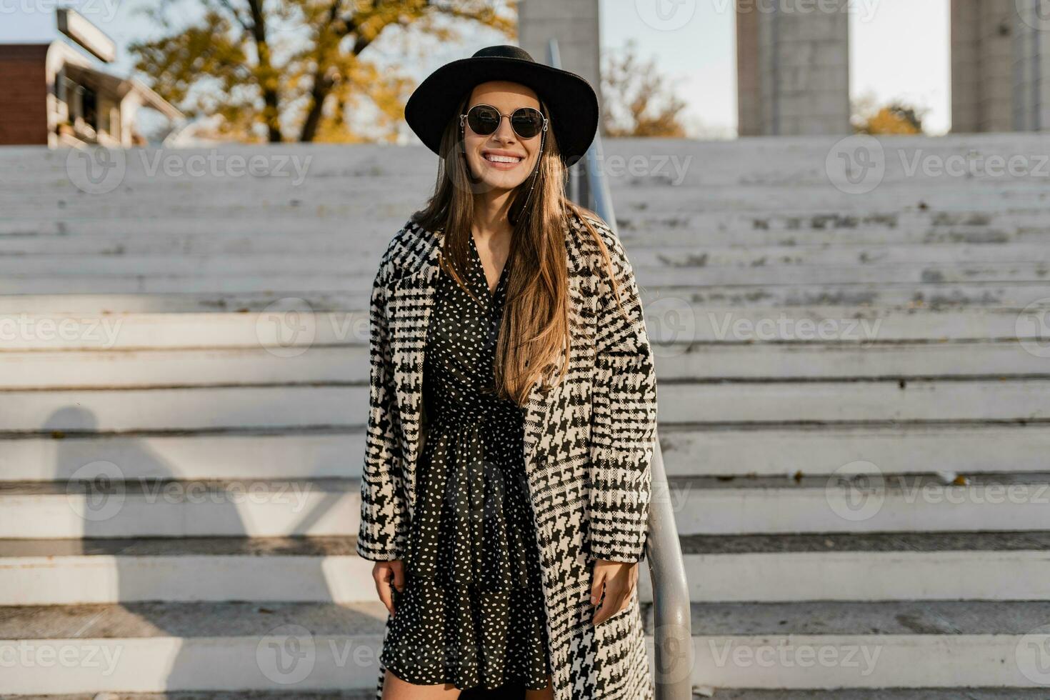 attractive young woman walking in autumn wearing coat photo