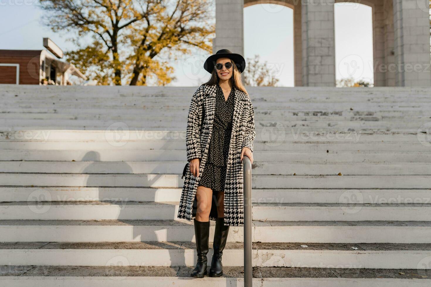 attractive young woman walking in autumn wearing coat photo